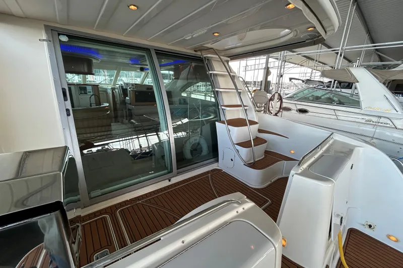 Slide: The Image of 1999 Maxum 4600 SCB yacht with illuminated deck, docked at night in Highland Village, TX. - 46