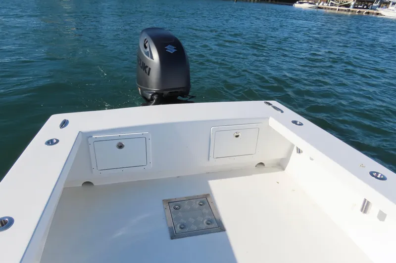 Slide: The Image of 1982 Privateer 20 Roamer Skiff with Suzuki outboard motor on calm water. - 17