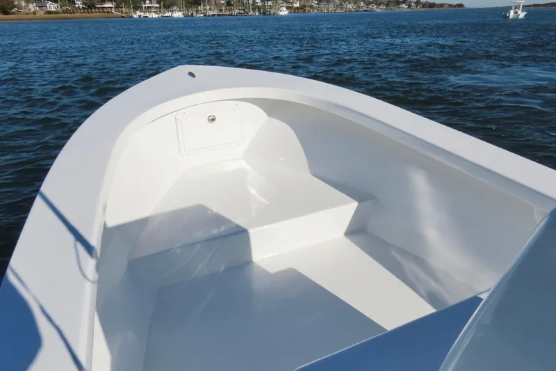 Slide: The Image of 1982 Privateer 20 Roamer Skiff on calm water, showcasing spacious interior design. - 19