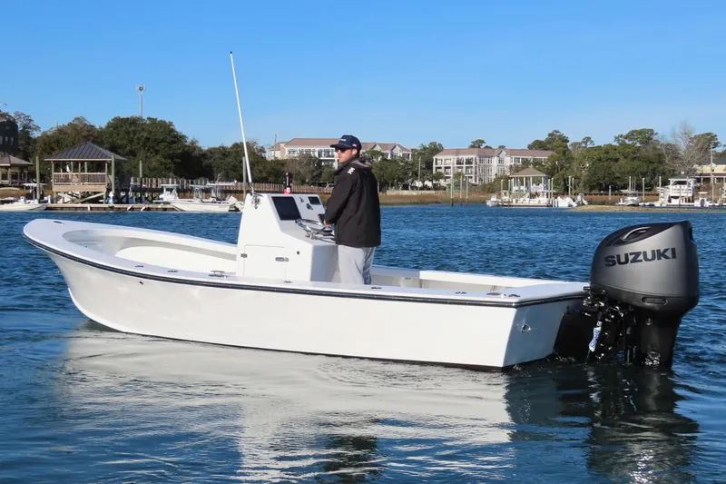 Slide: The Image of 1982 Privateer 20 Roamer Skiff with Suzuki outboard on calm water. - 4