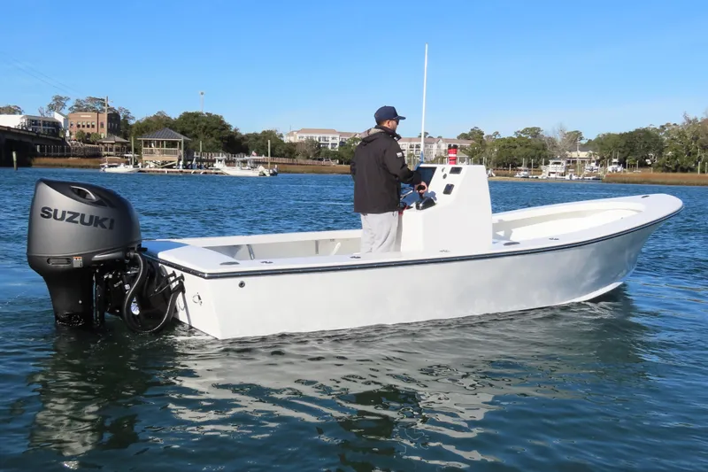 Slide: The Image of 1982 Privateer 20 Roamer Skiff with Suzuki outboard on calm water. - 7