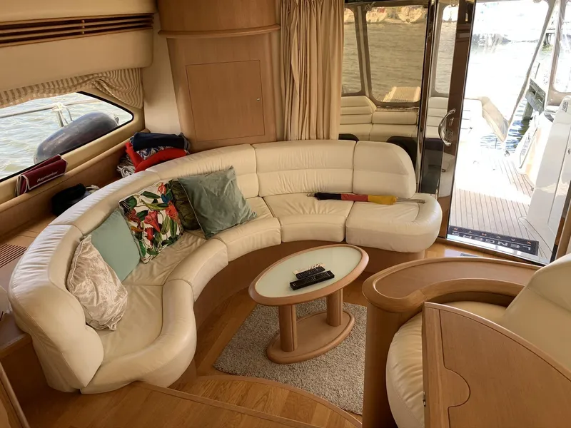 Slide: The Image of Luxurious 2003 Aicon 56 Flybridge yacht interior with curved leather seating and elegant decor. - 14