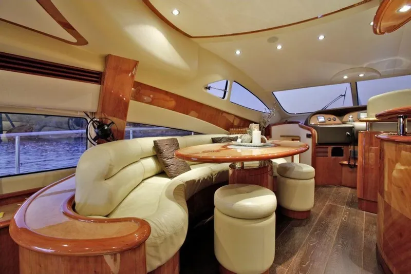 Slide: The Image of Luxurious interior of 2003 Aicon 56 Flybridge yacht with elegant seating and wooden finishes. - 15