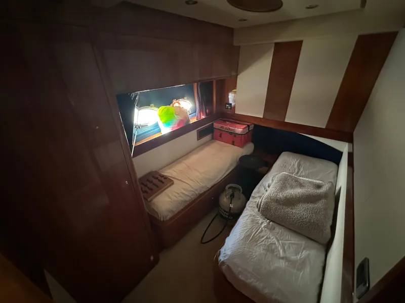 Slide: The Image of Cozy cabin interior of 2003 Aicon 56 Flybridge yacht with twin beds and wooden paneling. - 18