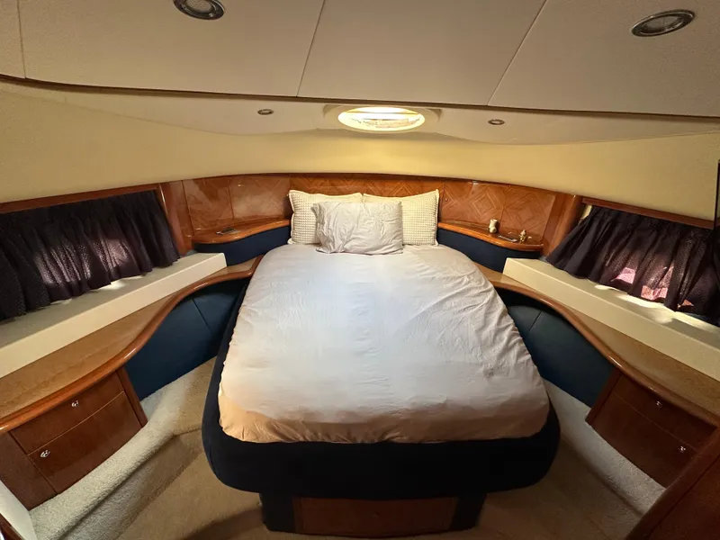 Slide: The Image of Luxurious bedroom interior of 2003 Aicon 56 Flybridge yacht with cozy bed and elegant wood accents. - 20