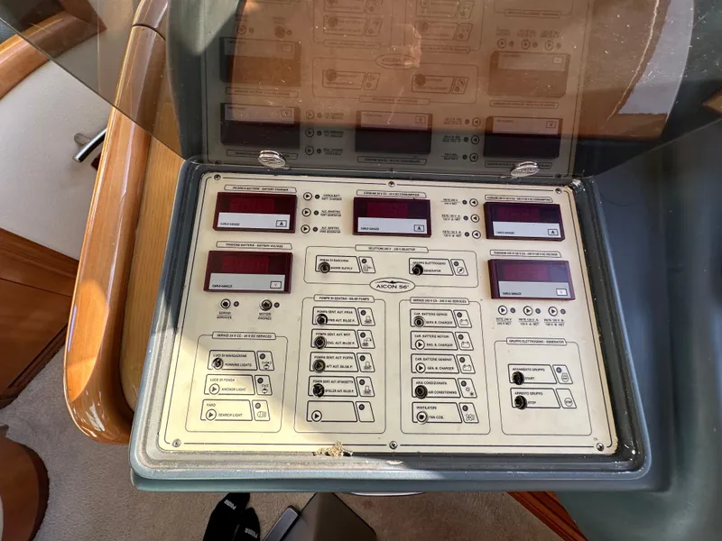 Slide: The Image of Control panel of 2003 Aicon 56 Flybridge yacht with various switches and displays. - 21