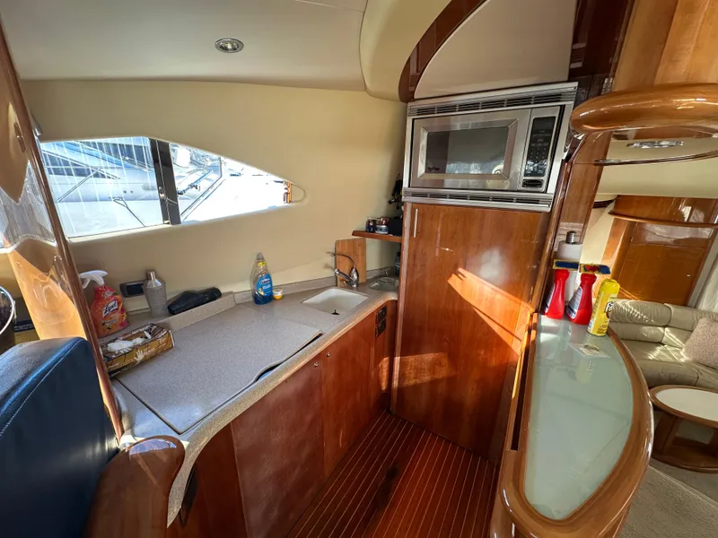 Slide: The Image of Interior of 2003 Aicon 56 Flybridge yacht kitchen with wood finish and appliances. - 22