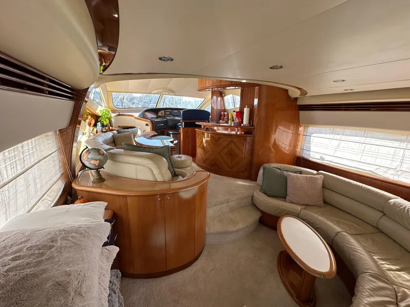 Slide: The Image of Luxurious interior of 2003 Aicon 56 Flybridge yacht with elegant wood finishes and plush seating. - 25