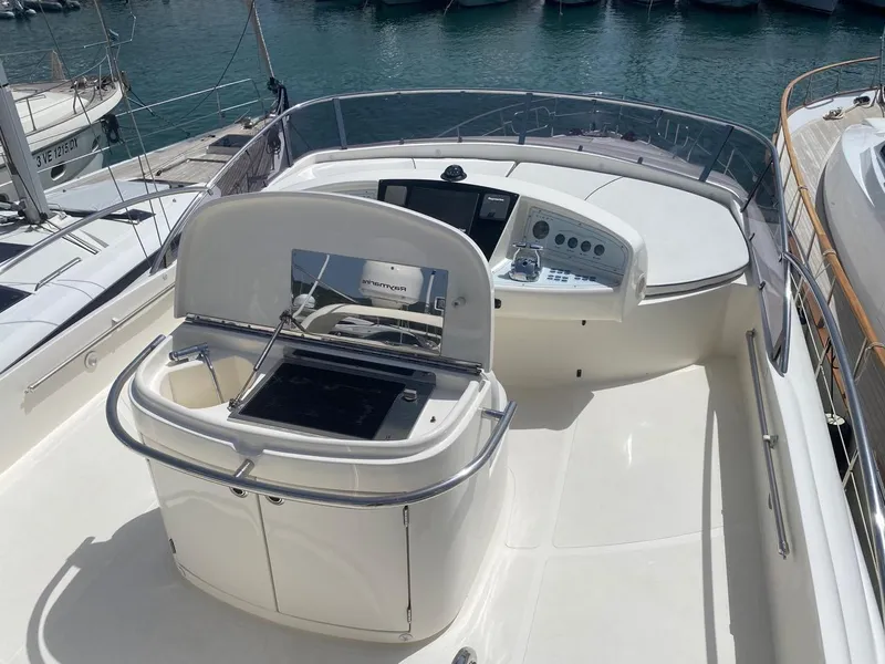 Slide: The Image of Aicon 56 Flybridge yacht deck, 2003 model, featuring helm and seating area. - 6