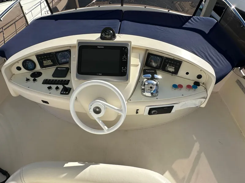 Slide: The Image of Aicon 56 Flybridge 2003 yacht helm with navigation controls and steering wheel. - 8