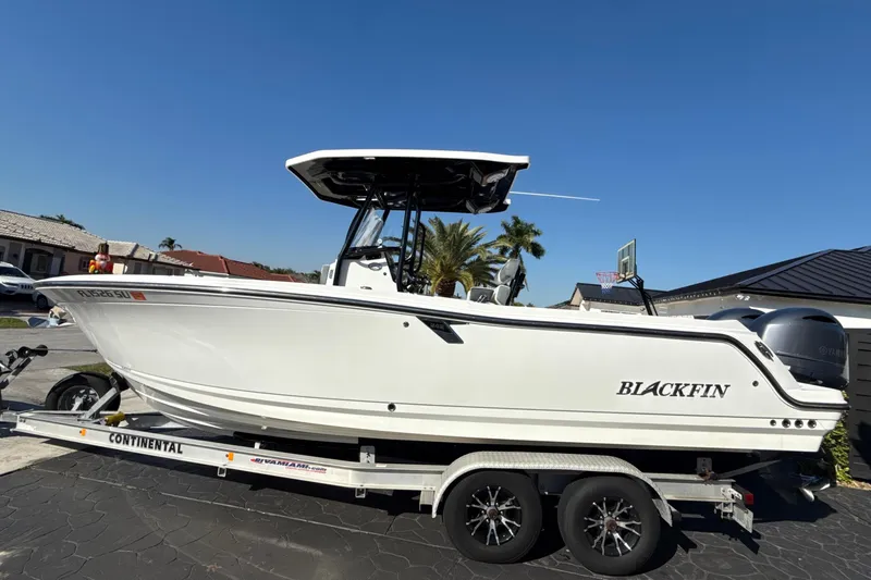 The Image of 2019 Blackfin 242 CC boat on trailer, parked in residential driveway. - 1