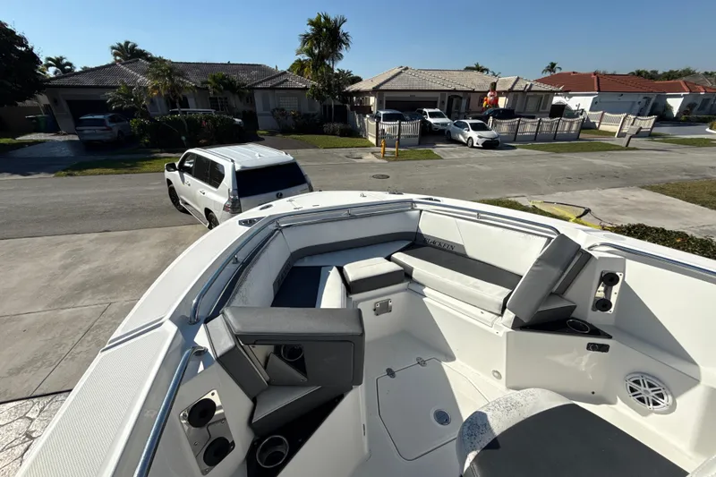 Slide: The Image of 2019 Blackfin 242 CC boat with seating, parked in a residential neighborhood. - 13