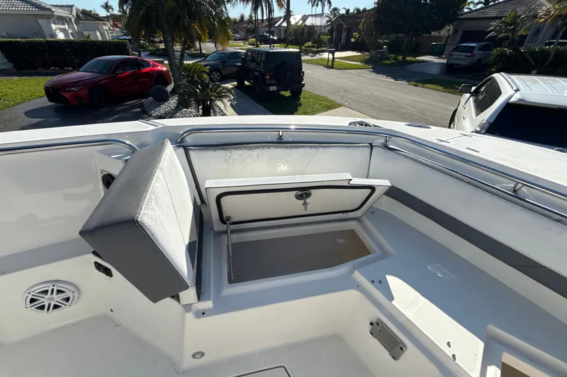 Slide: The Image of 2019 Blackfin 242 CC boat interior with open storage compartment and seating. - 16