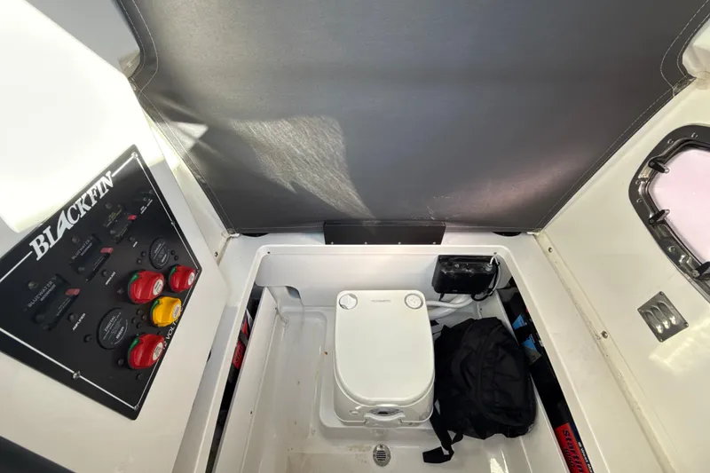Slide: The Image of Interior of 2019 Blackfin 242 CC boat with control panel and storage area. - 21