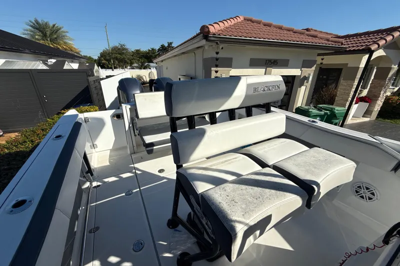 Slide: The Image of 2019 Blackfin 242 CC boat interior with white seating and sleek design. - 24