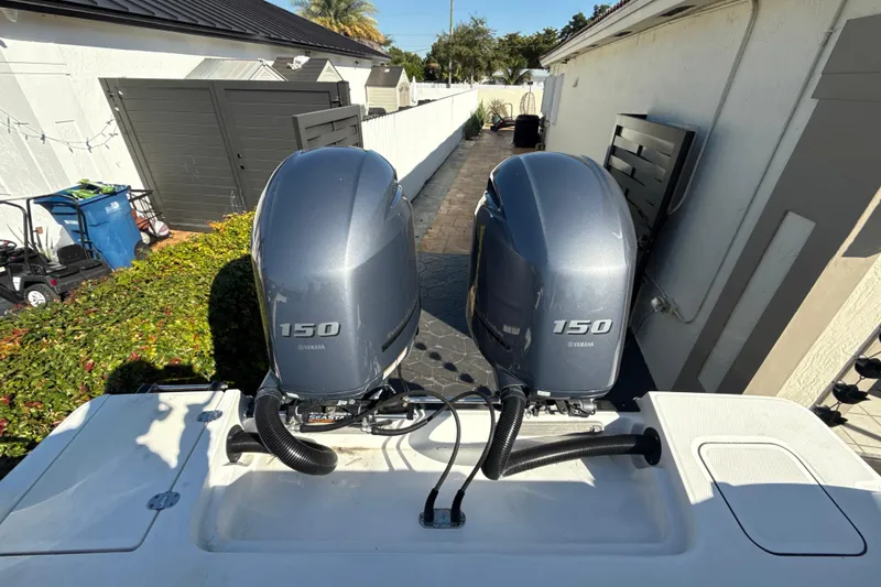 Slide: The Image of 2019 Blackfin 242 CC with dual Yamaha 150 outboard engines in a residential setting. - 6