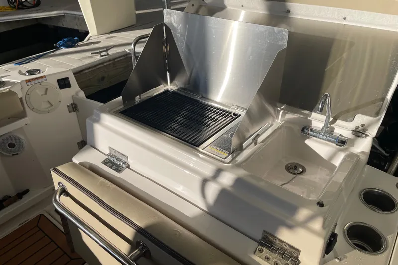 Slide: The Image of Outdoor kitchen on 2019 Ranger Tugs R-27 boat with grill and sink. - 13