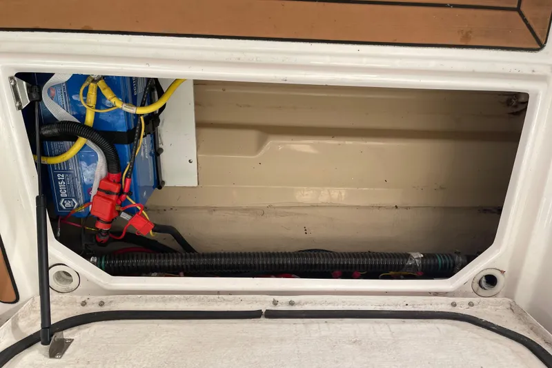 Slide: The Image of 2019 Ranger Tugs R-27 battery compartment with wiring and connections. - 15