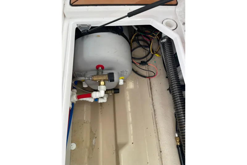 Slide: The Image of 2019 Ranger Tugs R-27 boat interior showing plumbing and wiring components. - 19