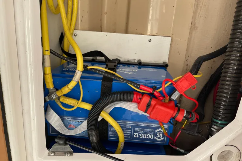 Slide: The Image of Battery compartment of 2019 Ranger Tugs R-27 with connected cables and wiring. - 20