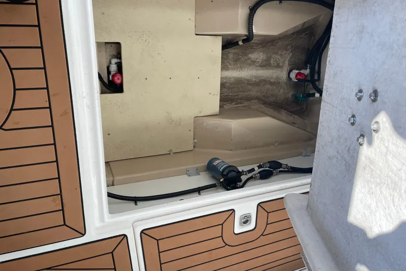 Slide: The Image of 2019 Ranger Tugs R-27 boat interior showing storage compartment and mechanical components. - 21