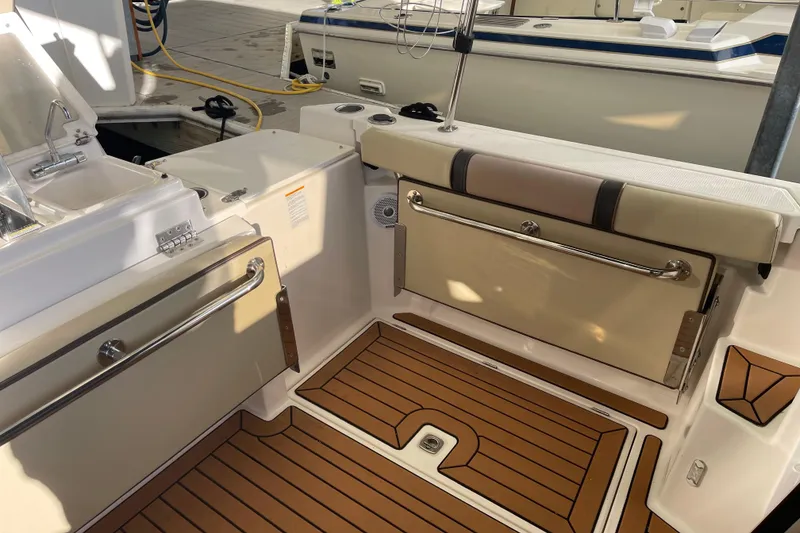 Slide: The Image of 2019 Ranger Tugs R-27 boat interior with teak flooring and seating area. - 22