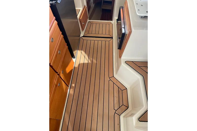 Slide: The Image of 2019 Ranger Tugs R-27 interior with wood flooring and cabinetry. - 24