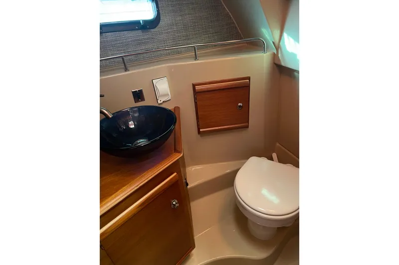 Slide: The Image of 2019 Ranger Tugs R-27 boat bathroom with modern sink and toilet. - 31
