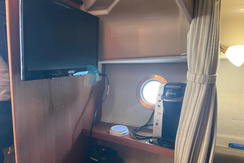 Slide: The Image of Interior of 2019 Ranger Tugs R-27 with TV, Keurig coffee maker, and porthole. - 32