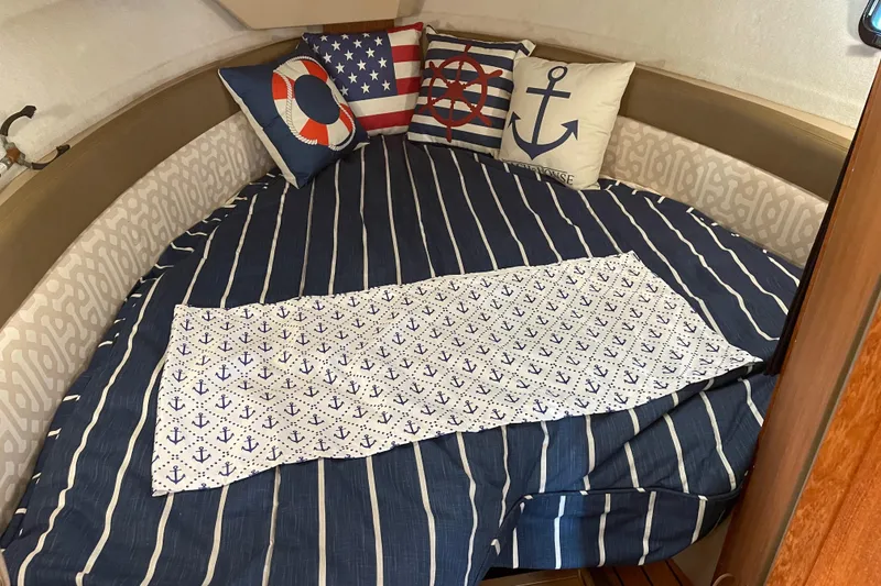 Slide: The Image of Cozy cabin interior of 2019 Ranger Tugs R-27 with nautical-themed bedding and pillows. - 33