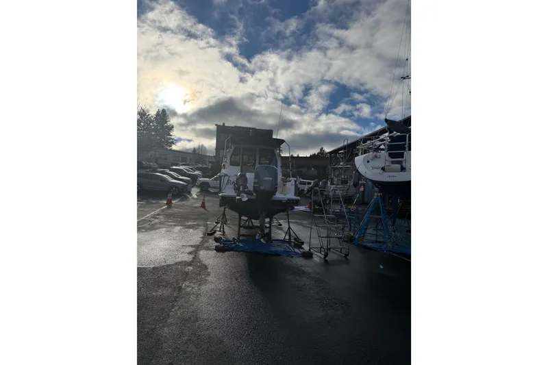 Slide: The Image of 2019 Ranger Tugs R-27 boat in a marina under a cloudy sky. - 41