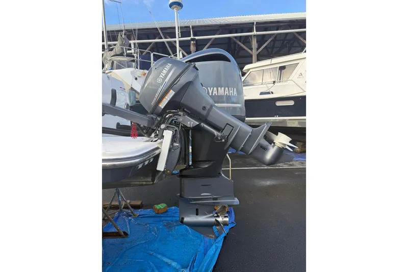 Slide: The Image of 2019 Ranger Tugs R-27 with Yamaha outboard motor, docked in a marina. - 46