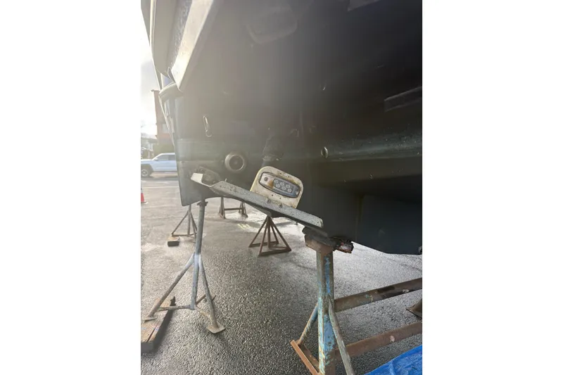 Slide: The Image of 2019 Ranger Tugs R-27 boat hull on stands, viewed from the rear. - 47