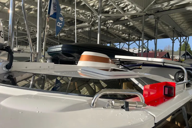 Slide: The Image of 2019 Ranger Tugs R-27 boat docked under a metal canopy, featuring deck equipment. - 5