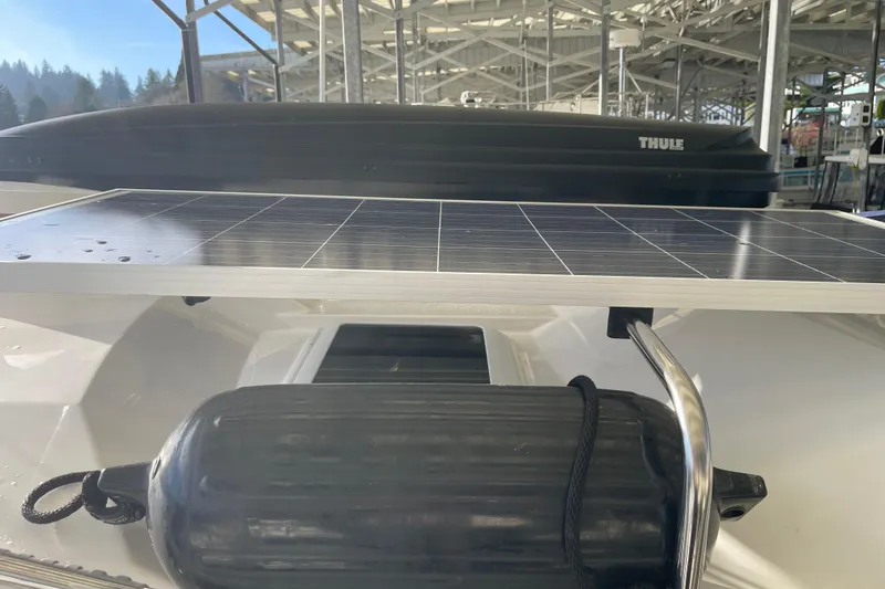Slide: The Image of 2019 Ranger Tugs R-27 with solar panel and fender under covered dock. - 6