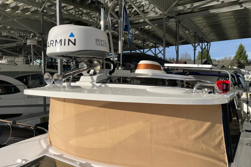 Slide: The Image of 2019 Ranger Tugs R-27 with Garmin xHD radar, docked under a covered marina. - 8