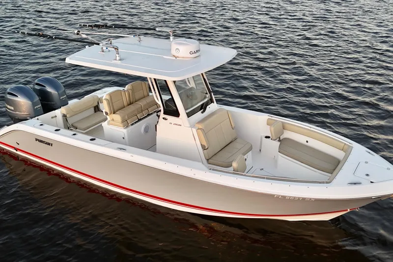 Slide: The Image of 2021 Pursuit S 268 Sport boat on water, featuring dual engines and spacious seating. - 13