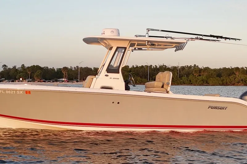 Slide: The Image of 2021 Pursuit S 268 Sport boat on calm water at sunset. - 14