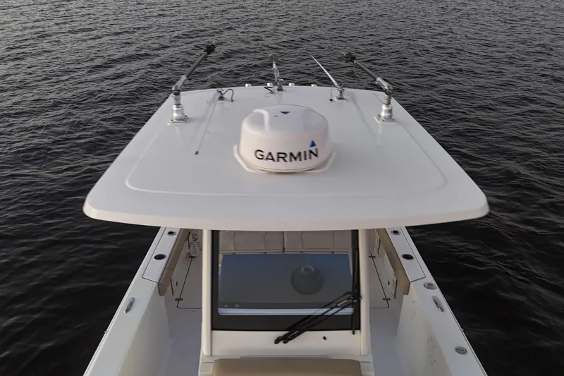 Slide: The Image of 2021 Pursuit S 268 Sport boat with Garmin equipment on calm water. - 17