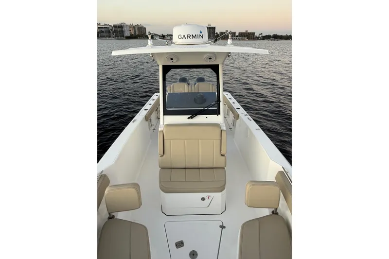 Slide: The Image of 2021 Pursuit S 268 Sport boat interior with Garmin equipment on calm water. - 19