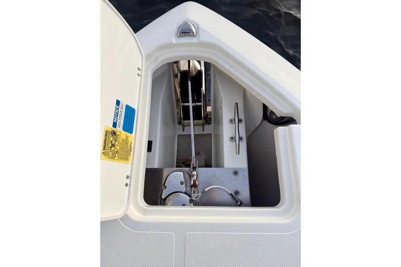 Slide: The Image of 2021 Pursuit S 268 Sport anchor locker with chain and cleat. - 24