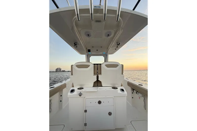 Slide: The Image of 2021 Pursuit S 268 Sport boat interior at sunset on the water. - 27