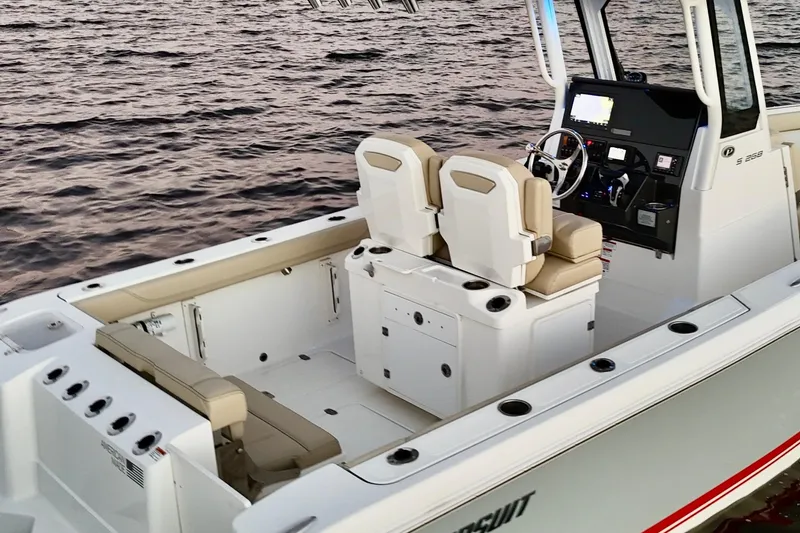 Slide: The Image of 2021 Pursuit S 268 Sport boat interior with dual seats and control panel on water. - 28