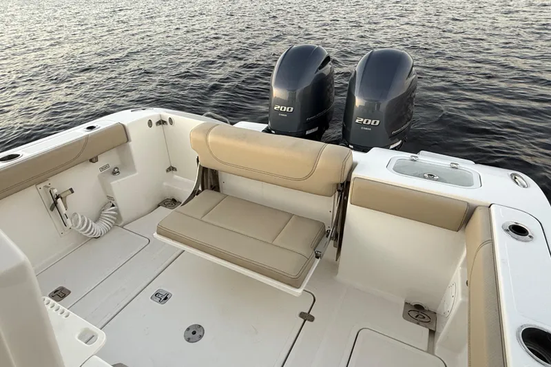 Slide: The Image of 2021 Pursuit S 268 Sport boat with dual Yamaha 200 engines on calm water. - 29