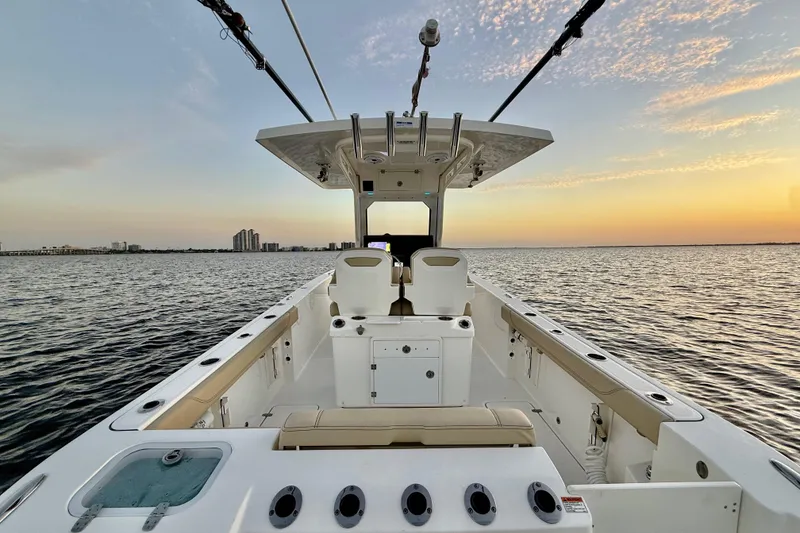 Slide: The Image of 2021 Pursuit S 268 Sport boat on calm water at sunset. - 30