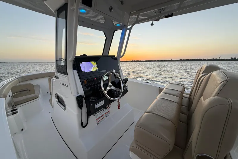 Slide: The Image of 2021 Pursuit S 268 Sport boat interior with sunset view over the water. - 31