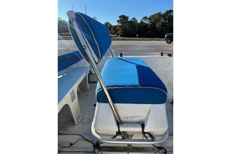 Slide: The Image of 2004 Carolina Skiff 17DLX boat seat with blue upholstery and metal frame. - 10