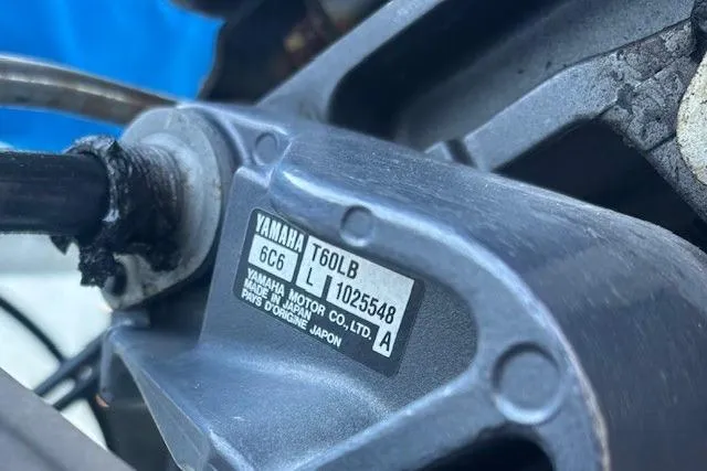 Slide: The Image of Close-up of a Yamaha T60LB motor part on a 2004 Carolina Skiff 17DLX boat. - 14