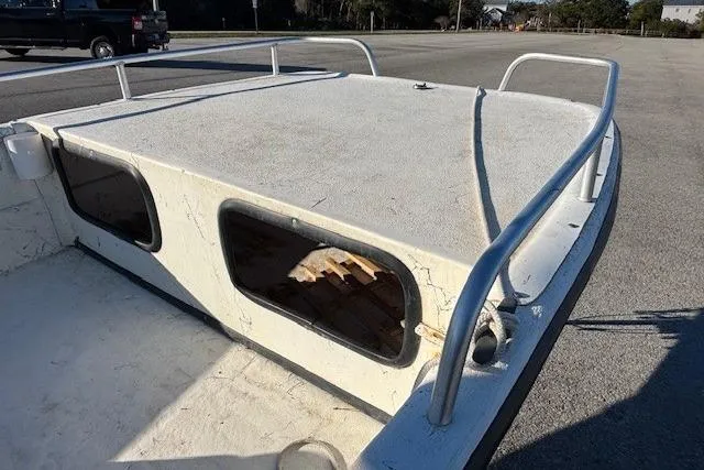 Slide: The Image of 2004 Carolina Skiff 17DLX boat deck with railing in a parking area. - 7