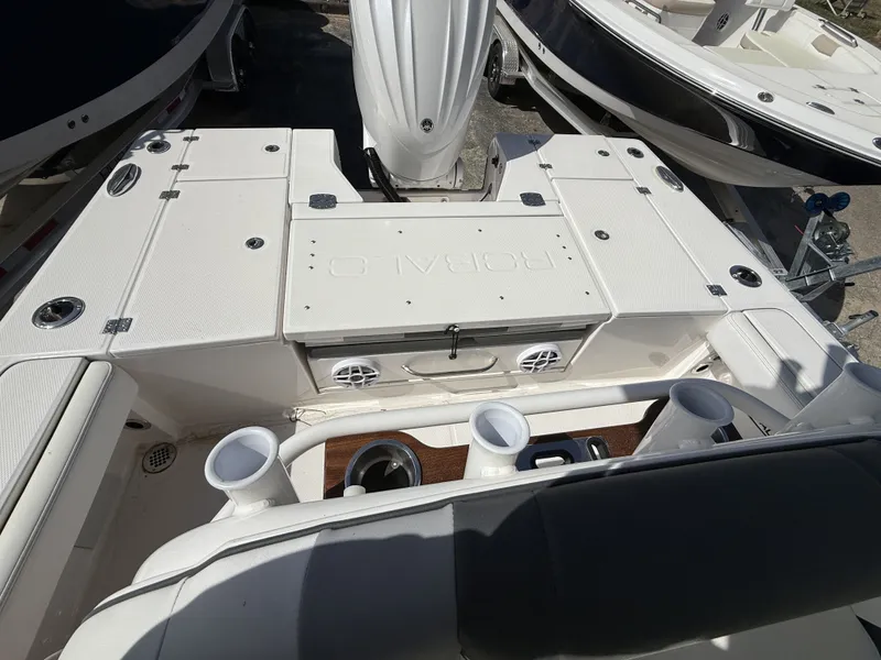 Slide: The Image of Robalo 246 Cayman 2026 boat rear with storage and cup holders. - 7